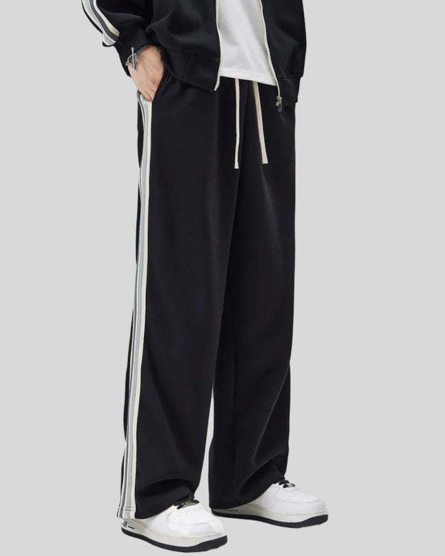 Model wearing TrackLine Club Pants in Black angled front view