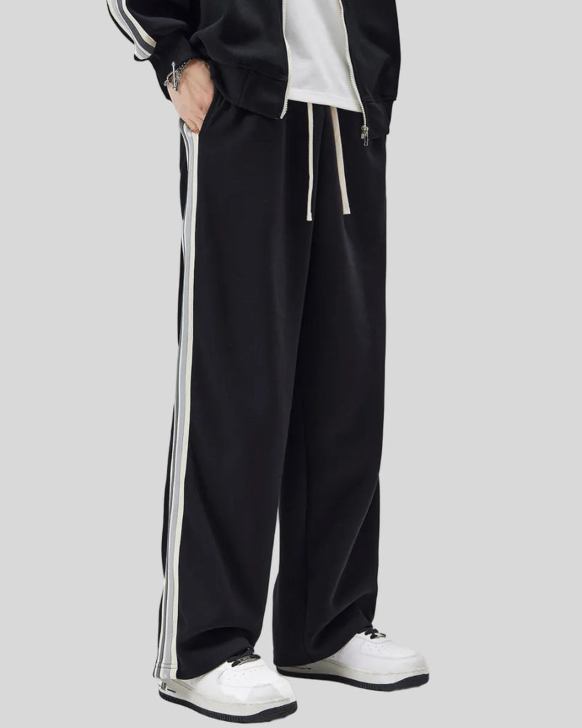 Model wearing TrackLine Club Pants in Black angled front view