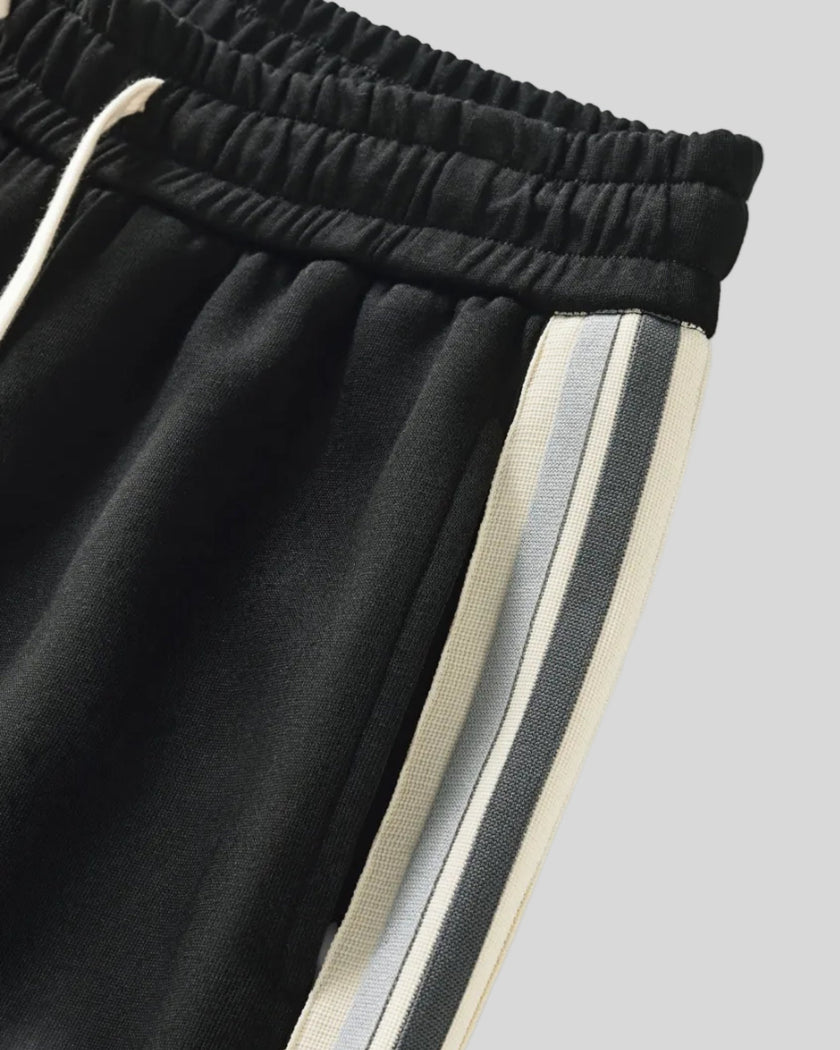 Contrast side stripe detail of TrackLine Club Pants in Black