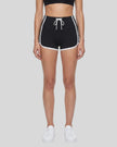 Model wearing the TrackLine Color Block Performance Shorts in Black, front view