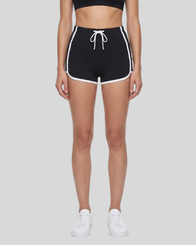 Model wearing the TrackLine Color Block Performance Shorts in Black, front view