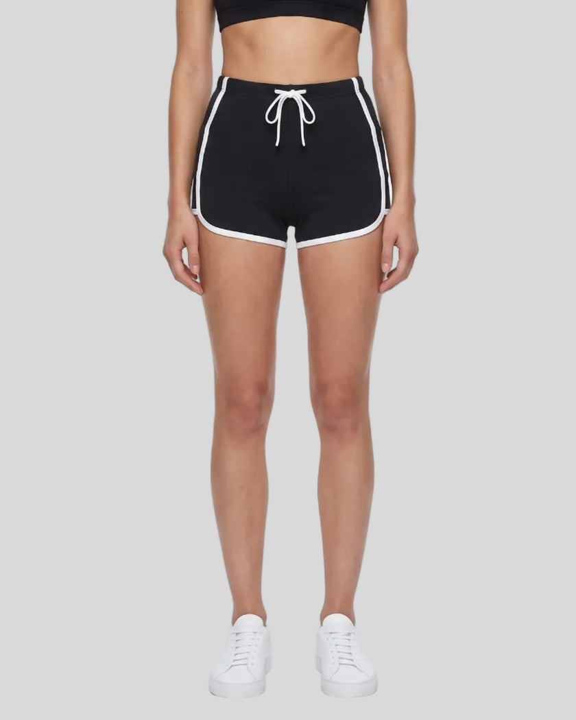 Model wearing the TrackLine Color Block Performance Shorts in Black, front view