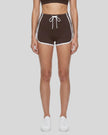 Model wearing the TrackLine Color Block Performance Shorts in Coffee, front view