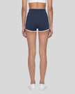 Model wearing the TrackLine Color Block Performance Shorts in Navy Blue, back view