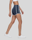 Model wearing the TrackLine Color Block Performance Shorts in Navy Blue, side angle view