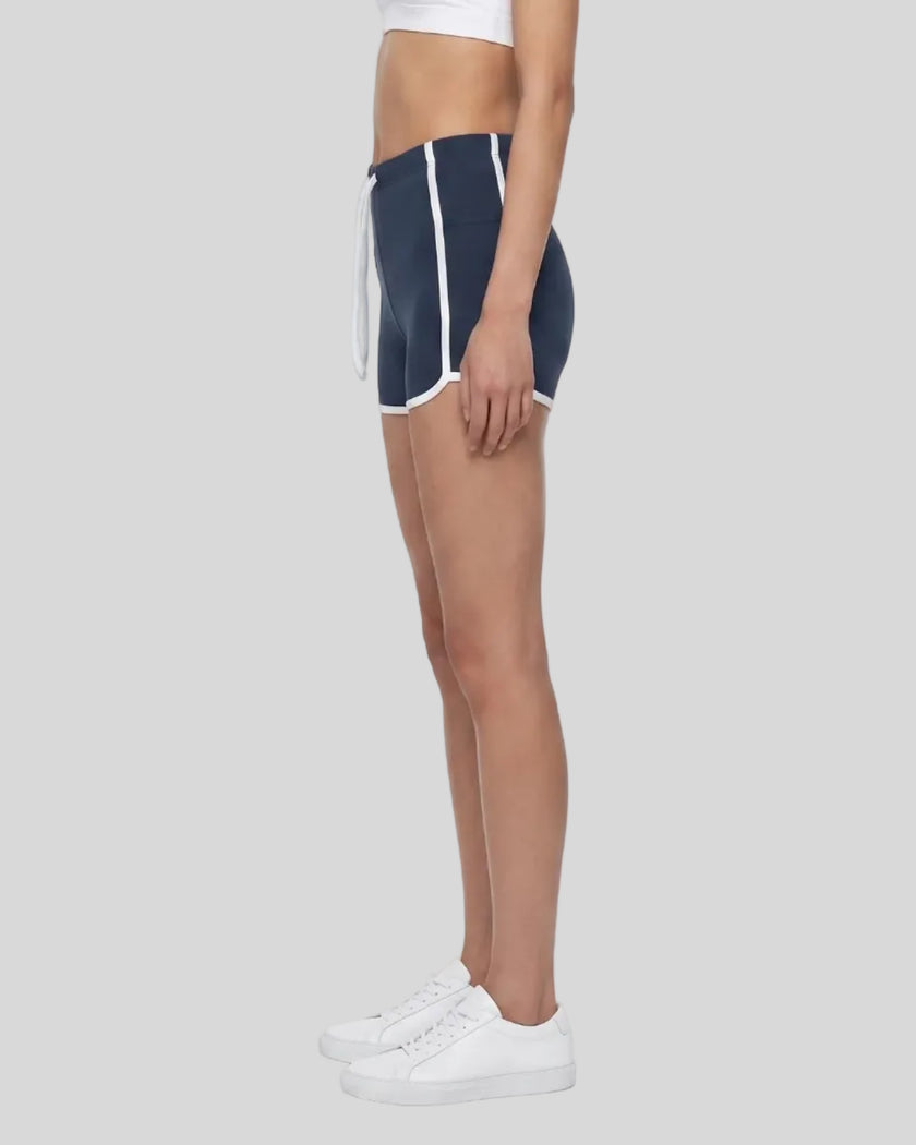 Model wearing the TrackLine Color Block Performance Shorts in Navy Blue, side view