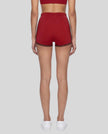Model wearing the TrackLine Color Block Performance Shorts in Red, back view