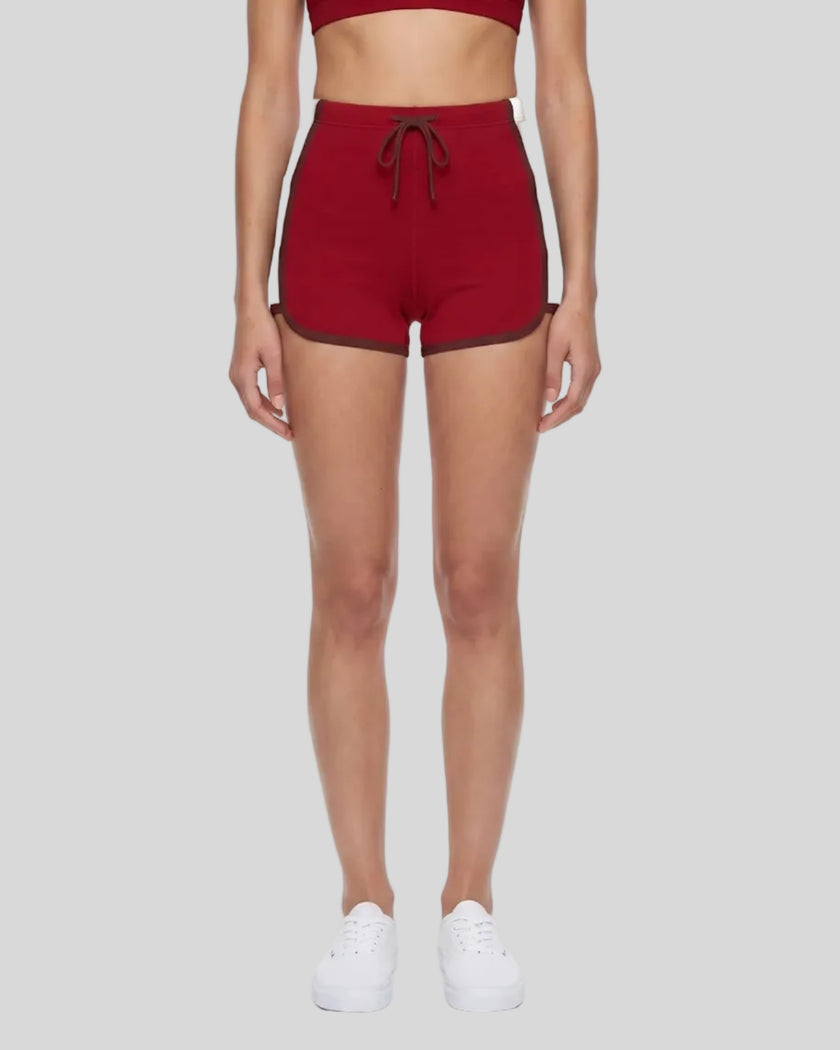Model wearing the TrackLine Color Block Performance Shorts in Red, front view