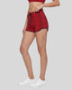 Model wearing the TrackLine Color Block Performance Shorts in Red, side view