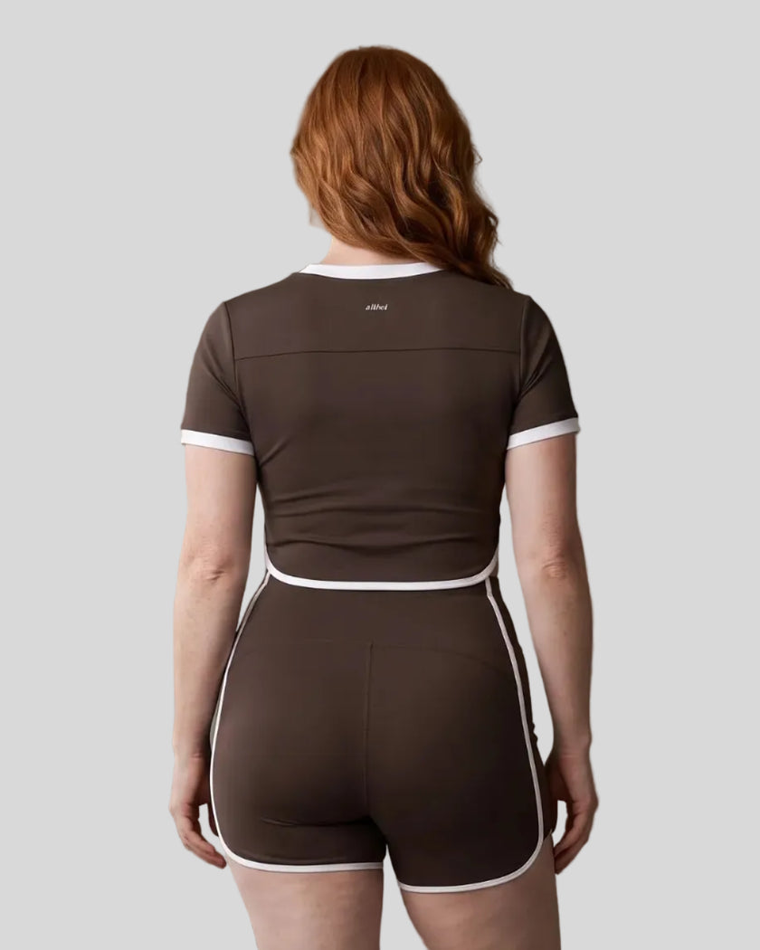 Model wearing the TrackLine Color Block Performance Tee in Coffee, back view