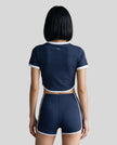 Model wearing the TrackLine Color Block Performance Tee in Navy Blue, back view