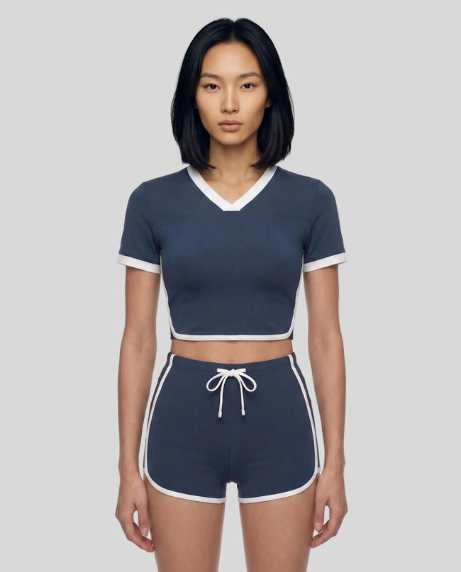 Model wearing the TrackLine Color Block Performance Tee in Navy Blue, front view