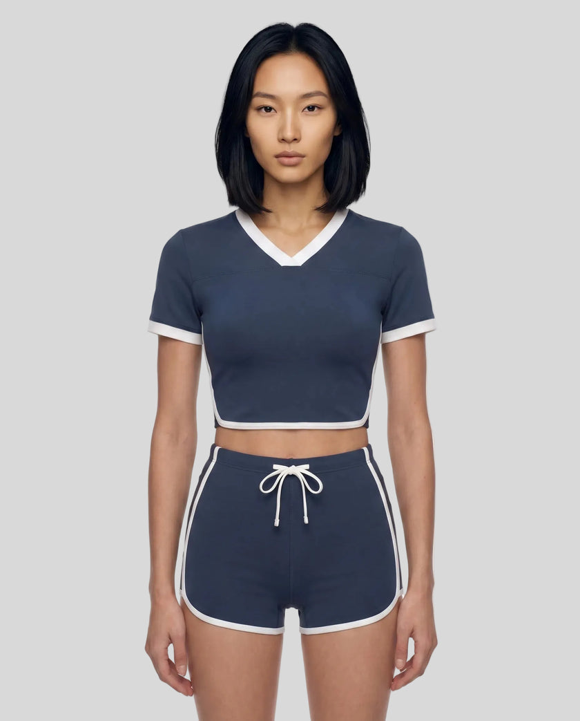 Model wearing the TrackLine Color Block Performance Tee in Navy Blue, front view