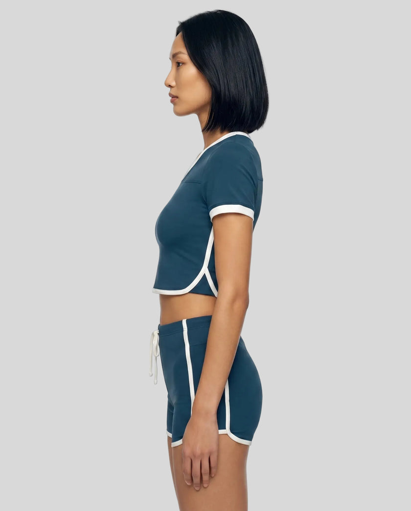 Model wearing the TrackLine Color Block Performance Tee in Navy Blue, side view