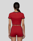 Model wearing the TrackLine Color Block Performance Tee in Red, back view