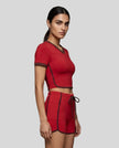 Model wearing the TrackLine Color Block Performance Tee in Red, side view
