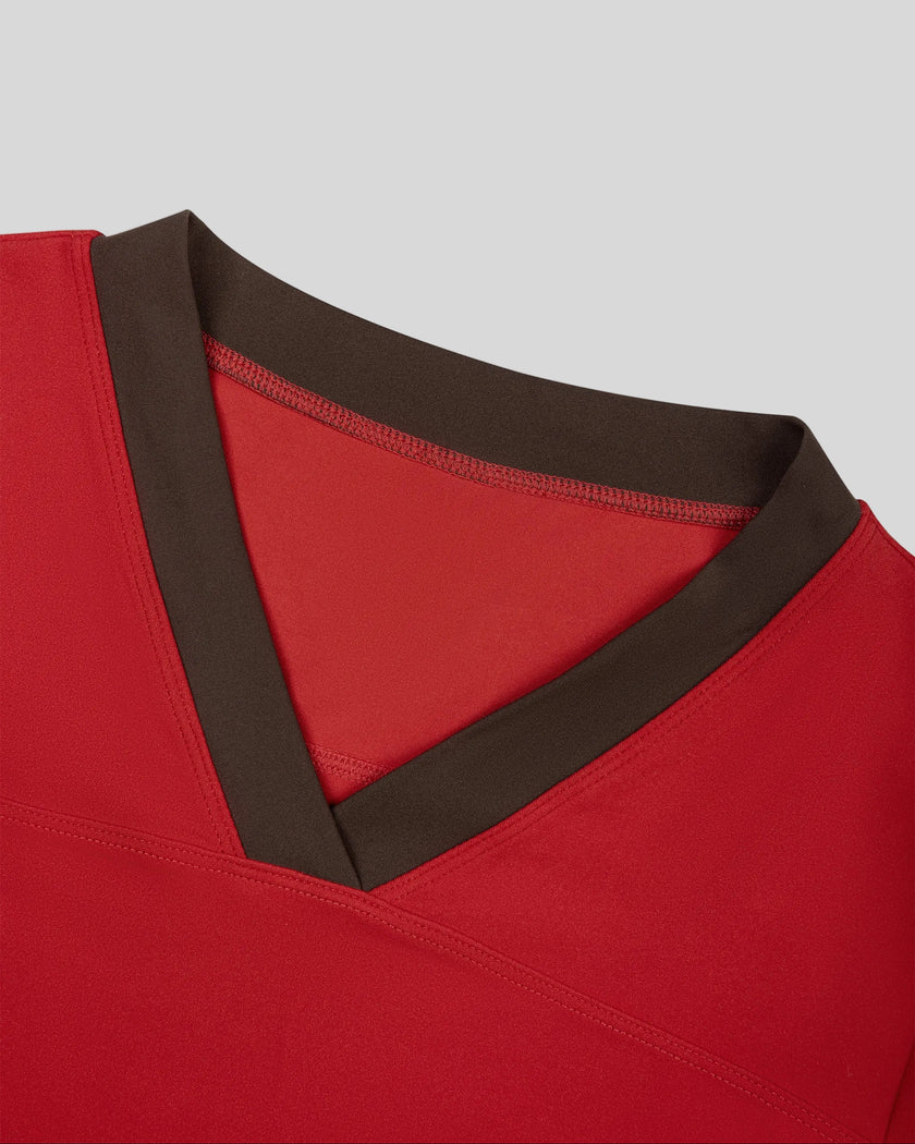 Closeup of the V-neck contrast trim on the TrackLine Color Block Performance Tee in Red