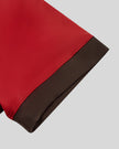Closeup of the contrast sleeve hem on the TrackLine Color Block Performance Tee in Red