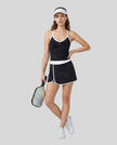 Woman wearing Athlesi TrackLine Color Block Skort in Black full-body front view