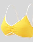 Angled closeup of the Athlesi TrackLine Color Block Sports Bra in yellow and white