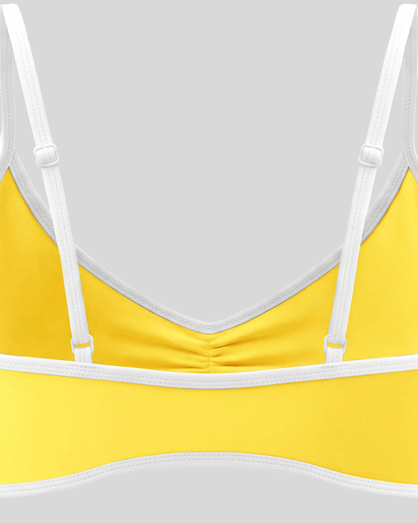 Back strap detail of the Athlesi TrackLine Color Block Sports Bra in yellow and white