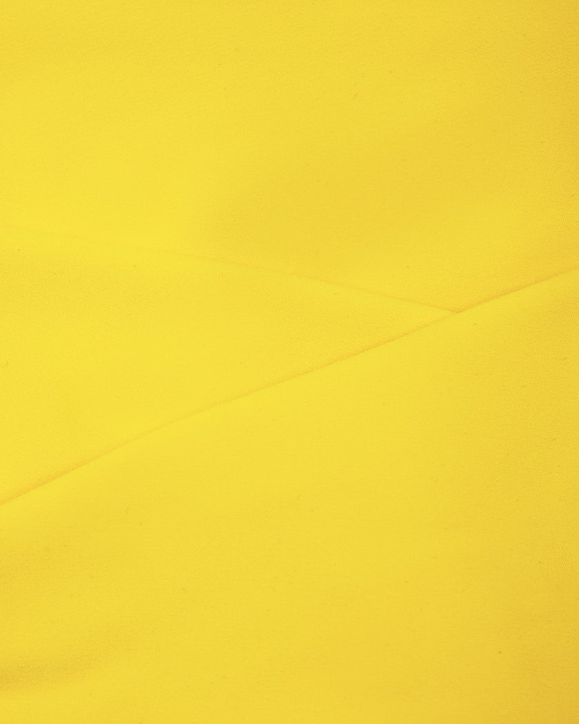 Smooth stretch fabric texture of the Athlesi TrackLine Color Block Sports Bra in yellow and white