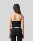 Back view of the TrackLine Color Block Tank in black and white, showing the shoulder strap design