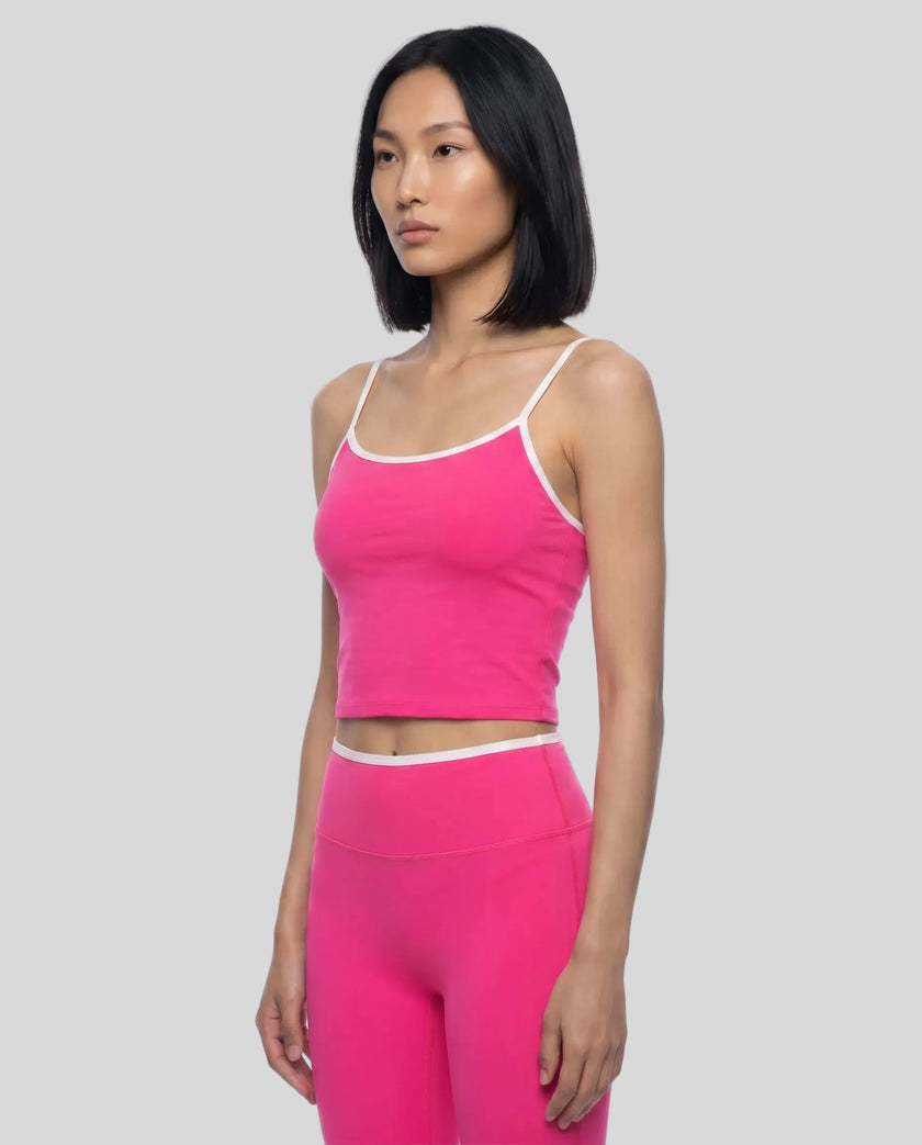 Angled front view of the TrackLine Color Block Tank in pink and white, styled with Trackline Sculpt Leggings