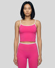 Model wearing the TrackLine Color Block Tank in pink and white front view
