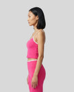 Side view of the TrackLine Color Block Tank in pink and white, highlighting the slim athletic fit