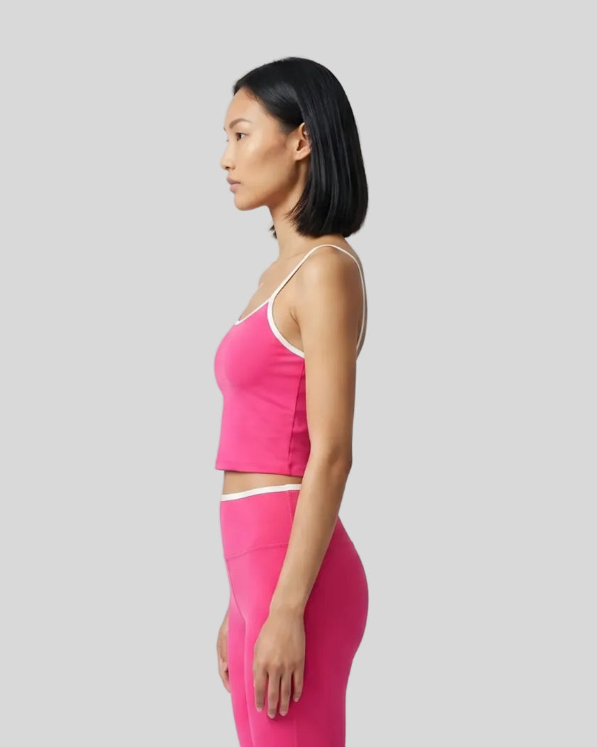 Side view of the TrackLine Color Block Tank in pink and white, highlighting the slim athletic fit