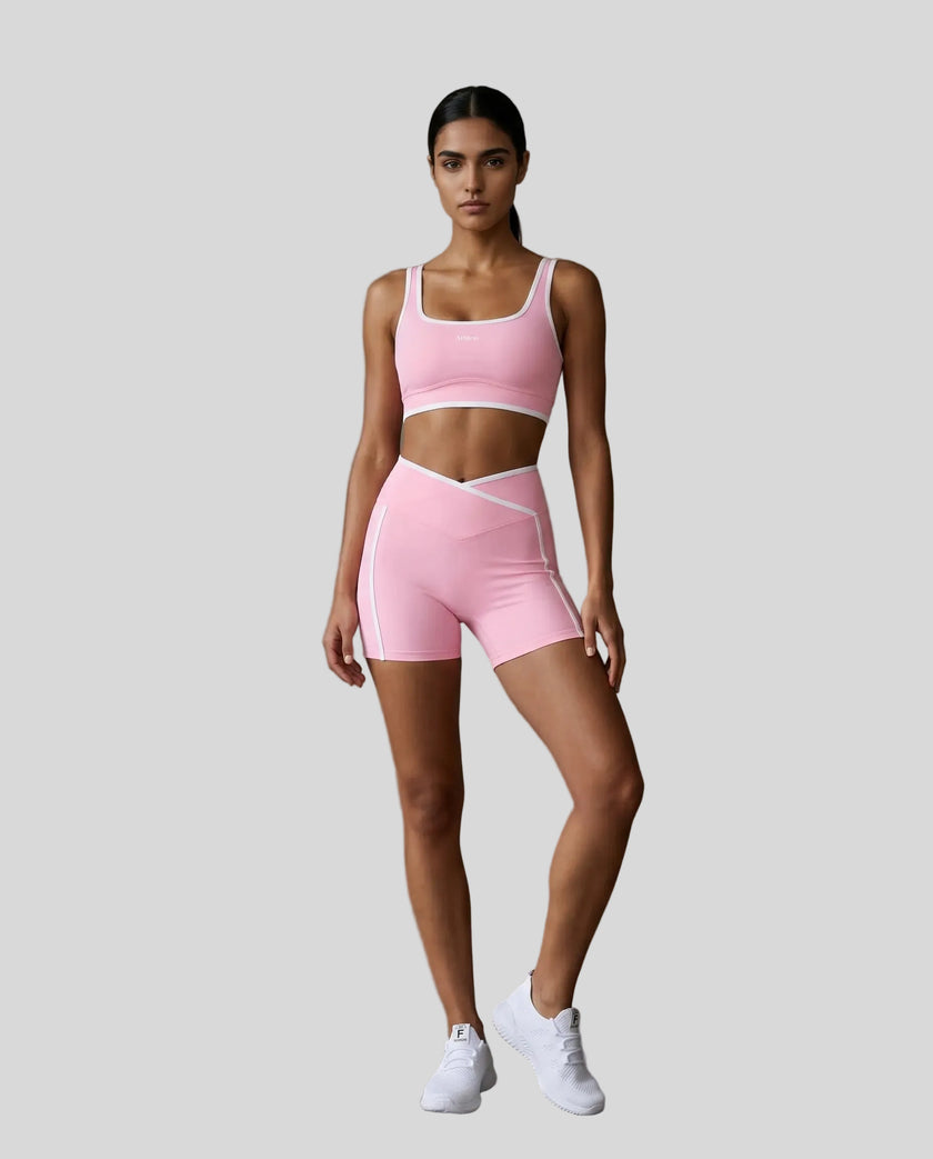 Model wearing the TrackLine Color Block Yoga Shorts in Light Pink and White full body front view