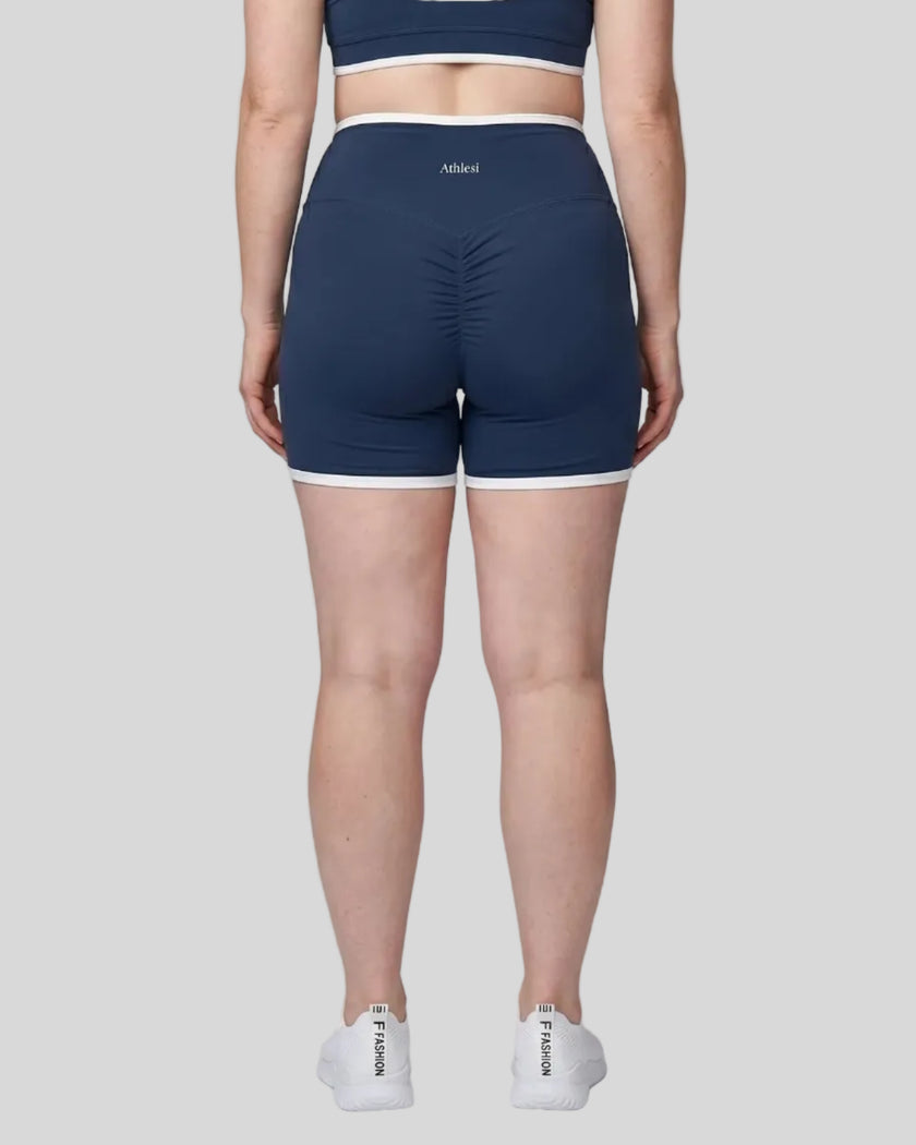 Model wearing the X-Large TrackLine Color Block Yoga Shorts in Navy Blue and White back view