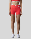 Model wearing the TrackLine Color Block Yoga Shorts in Red and White front view
