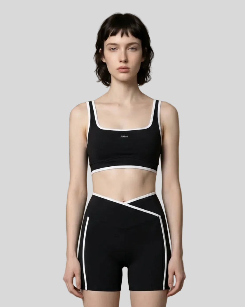 Model wearing the small-size Color Block Yoga Sports Bra in Black and White front view