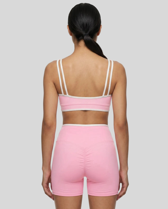 Back view of the TrackLine Color Block Yoga Sports Bra in Light Pink and White