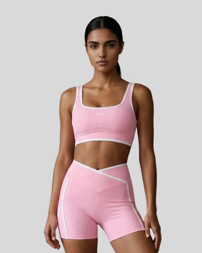 Model wearing the TrackLine Color Block Yoga Sports Bra in Light Pink and White front view