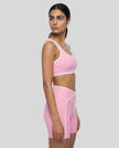 Side view of the TrackLine Color Block Yoga Sports Bra in Light Pink and White