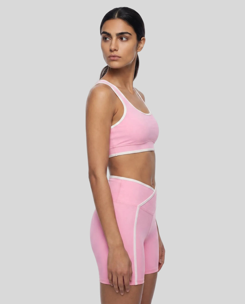 Side view of the TrackLine Color Block Yoga Sports Bra in Light Pink and White