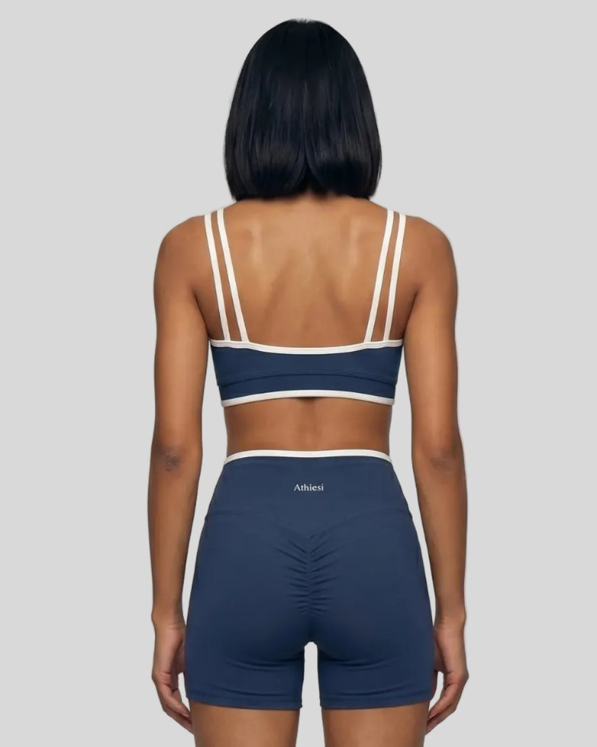 Model wearing the small-size Color Block Yoga Sports Bra in Navy Blue and White back view