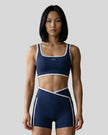 Model wearing the small-size Color Block Yoga Sports Bra in Navy Blue and White front view