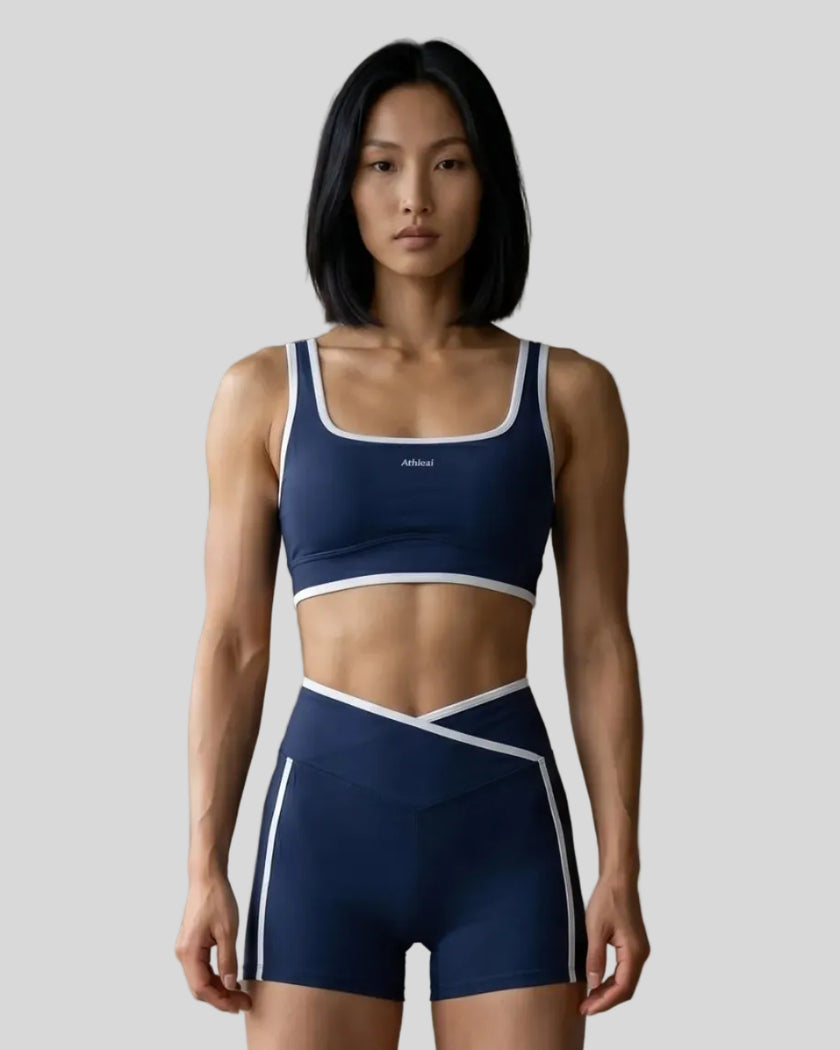 Model wearing the small-size Color Block Yoga Sports Bra in Navy Blue and White front view