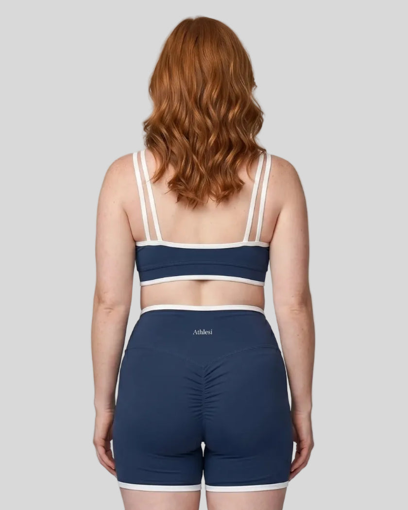 Model wearing the xlarge-size Color Block Yoga Sports Bra in Navy Blue and White back view