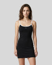 Mid body front view of a woman wearing the Athlesi TrackLine Contour Dress in black