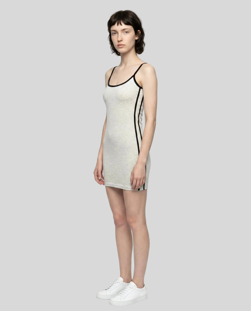 Full body left angle view of a woman wearing the Athlesi TrackLine Contour Dress in oat gray