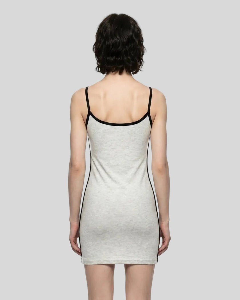 Back view of a woman wearing the Athlesi TrackLine Contour Dress in oat gray