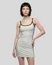 Front angle view of a woman wearing the Athlesi TrackLine Contour Dress in oat gray