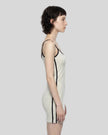 Side view of a woman wearing the Athlesi TrackLine Contour Dress in oat gray