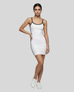 Full body front view of a woman wearing the Athlesi TrackLine Contour Dress in white