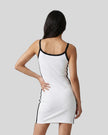 Back view of a woman wearing the Athlesi TrackLine Contour Dress in white
